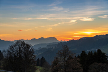 Sunset over Mount Saentis in Swiss Alps with Bregenzerwald, Austria, Vorarlberg, in foreground