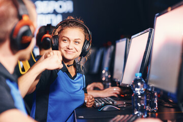 Winning. Two young happy professional cyber sport gamers giving fist bump and celebrating success while participating in eSports tournament © Friends Stock