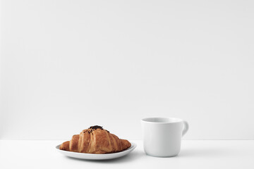 Mug and croissants on a white background. Eco-friendly and natural materials in the decor, dessert. Copy space, mock up.