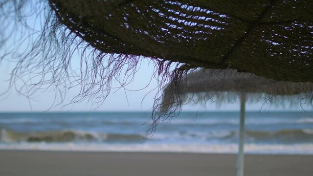 Beach umbrella on the empty closed beach during pandemic time in 4k slow motion 60fps