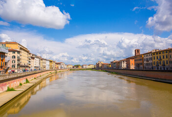 Fototapeta na wymiar Colorful, old buildings on River Arno in Pisa, Italy 