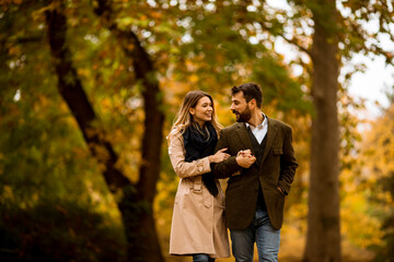 Young couple walking in the autumn park