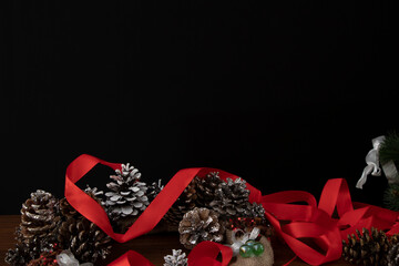 Christmas needlework, pine cone wreath and red ribbon, festive background. Holidays.