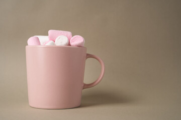 Glass with cocoa and marshmallows stands on an isolated background