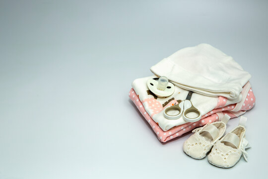 A pile of baby clothes and accessories.