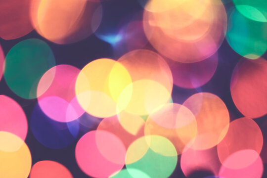 Abstract bokeh background made of defocused of Christmas lights, retro color toned picture.