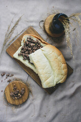 Top view of bread with choco crunchy spread on board, gray background