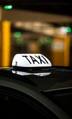 Taxi sign at the city during the night