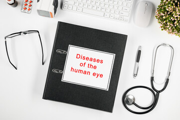 Doctor's workspace, in the center is a folder with the inscription: disease of the human eye