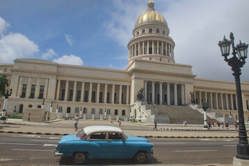 Classic auto drives past the Capitolio building, Havana, Cuba