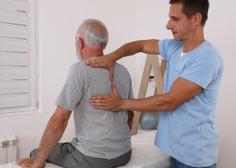 Chiropractic / Osteopathy treatment, Back pain relief. Physiotherapy for senior male patient