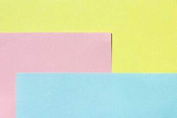 yellow, pink, and blue sheet of paper. multi-colored light background