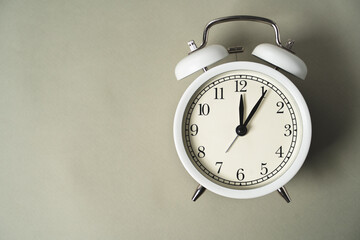 alarm clock with a dial lies on a gray background, business idea, time is money