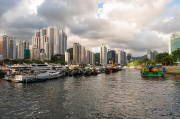 Fototapeta premium Aberdeen Harbour seen from Ap Lei Chau Bridge, In this area you will find fishing boats, houseboats, and sampans, The bay between the south coast of Hong Kong Island