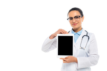 Smiling african american doctor showing digital tablet with blank screen isolated on white