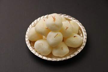 Famous Indian dessest rasgulla/ rosogulla/ roshogulla served in silver plate / bowl