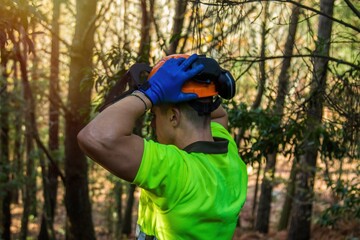 construction worker adjusting helmet to head