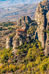 Fototapeta na wymiar Agios Nikolaos monastery, an unesco world heritage site, located on a unique rock formation above the village of Kalambaka during fall season.
