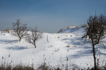 snow covered sand dunes with sky