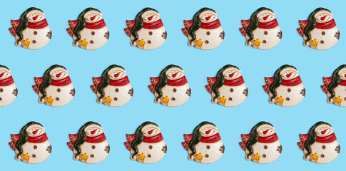 Banner. Seamless pattern. Figurines of snowmen on a blue background. Christmas card.