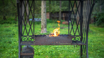 Good old wrought iron metal brazier on a summer day
