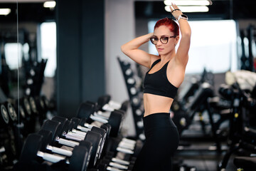 athletic woman smiling working out in the gym. Fitness personal trainer training, working out fitness lifestyle