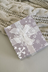 Christmas gifts ,grey knitted blanket on grey background