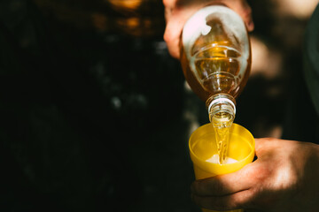 Pour draft beer into a cup