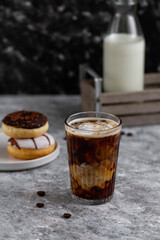 Glass of hot coffee with milk. Coffee and donuts