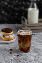 Glass of hot coffee with milk. Coffee and donuts