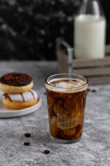 Glass of hot coffee with milk. Coffee and donuts