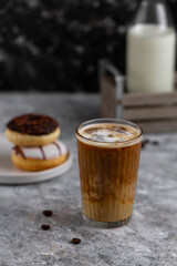 Glass of hot coffee with milk. Coffee and donuts