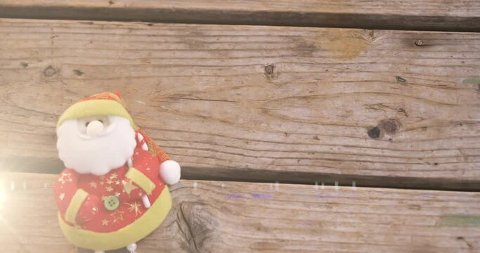 Animation of santa claus christmas decoration on wooden surface