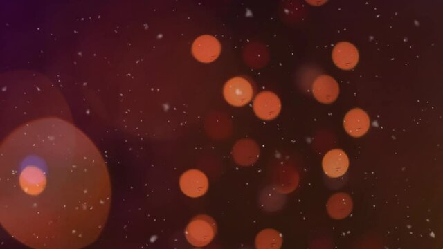 Digital animation of snow falling over orange spots of light against black background