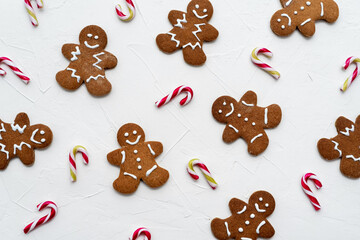 Christmas candy cans and gingerbreads man cookies on white background