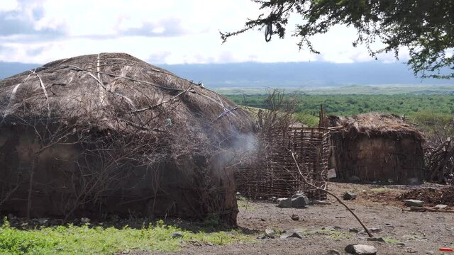 Kitchen Smoke Seeps out From Traditional Maasai Clay Round Hut in Engare Sero area near Lake Natron and Ol Doinyo Lengai volcano in Tanzania, Africa
