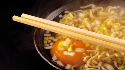 Hot noodle soup with egg and leek.