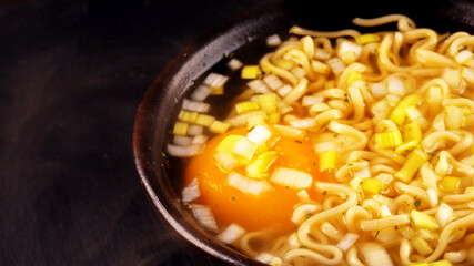 Hot noodle soup with egg and leek.