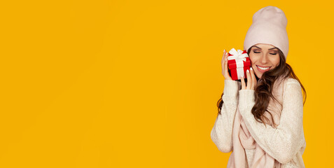 A portrait of an outspoken contented girl enjoys a gift box she