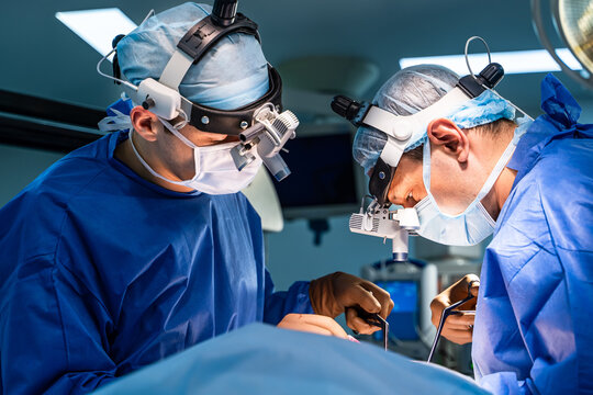 Equipment and medical devices in modern operating room. Operating theatre. Selective focus on neurosurgeons` work.