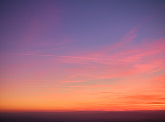 Evening colorful purple-pink sky with red clouds and orange horizon. Aerial photography, sky over the whole photo. Photo perfect for background exchange.