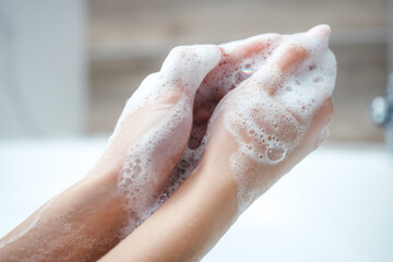 Fototapeta premium Caucasian Woman use soap and washing hands under the water tap. Hygiene concept hand detail.