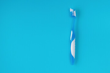 old used toothbrush on a blue background