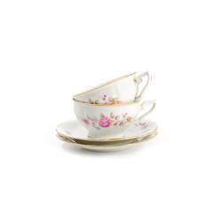 Vintage tea or coffee cups and saucers with flowers and white background