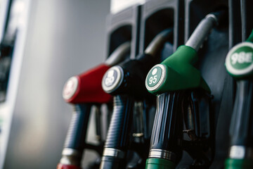 Multicolor guns in the gas station. Different pump nozzles. Vintage glow photo of station's row of pistols.