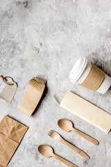 breakfast take away with paper bags on gray table background top view mock up