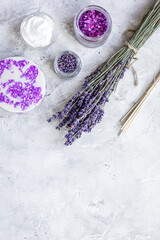 Obraz na płótnie Canvas natural herb cosmetic with lavender flatlay on stone background top view mockup