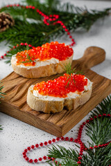 Red caviar on baguette toast. Holiday, new year, Christmas, buffet.