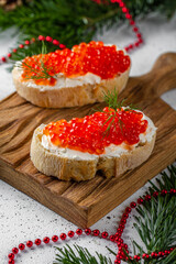 Red caviar on baguette toast. Holiday, new year, Christmas, buffet.