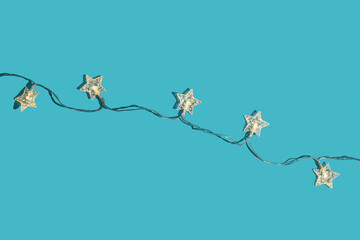 Christmas minimal festive background with star garland. Abstract christmas background shiny blue ai aqua. Flat lay. Top view.